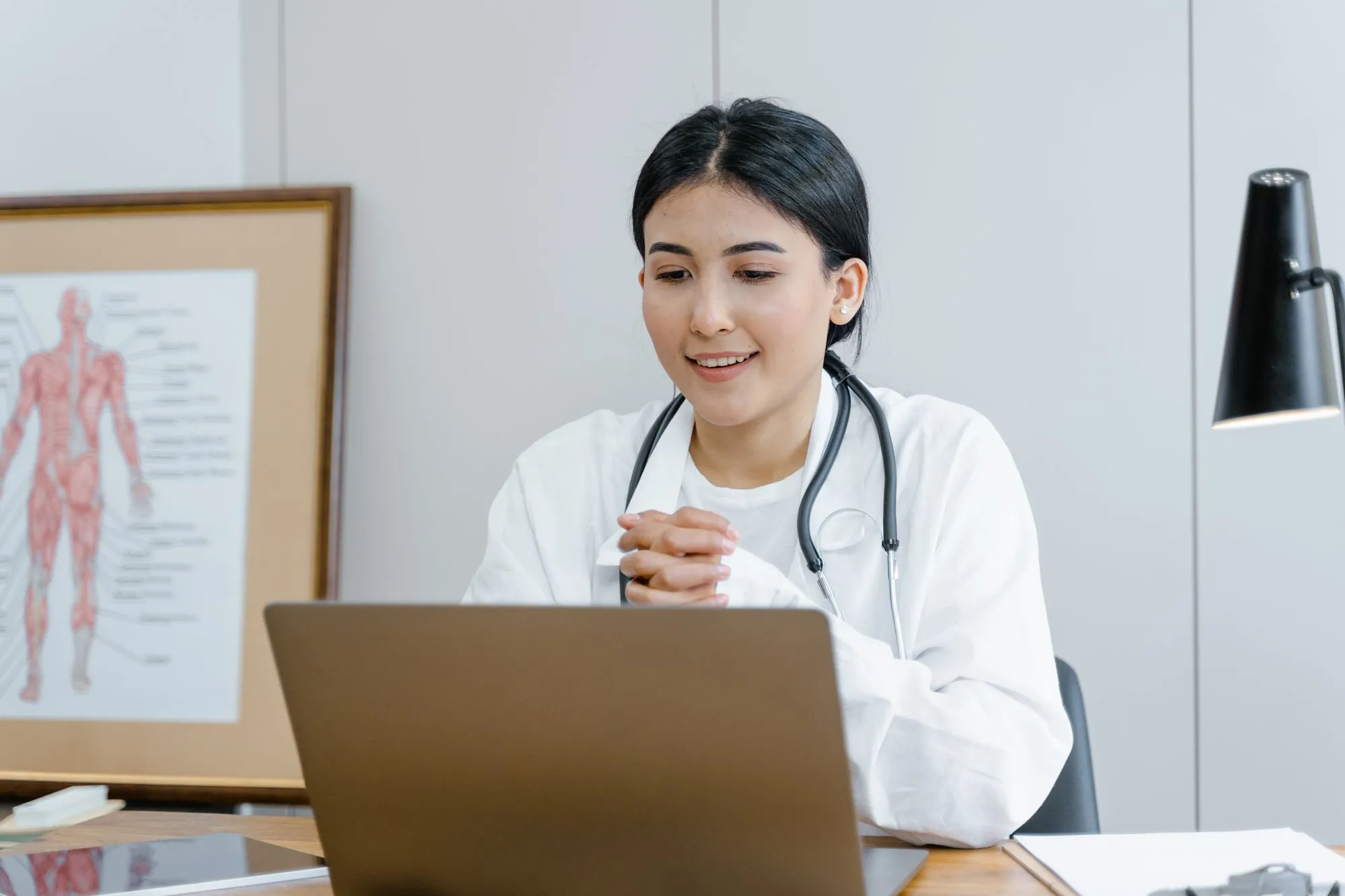 Provider checking in with a patient on a laptop
