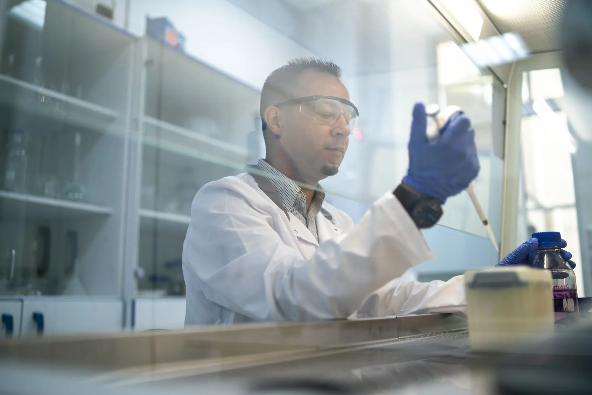 Researcher using a pipette in a laboratory