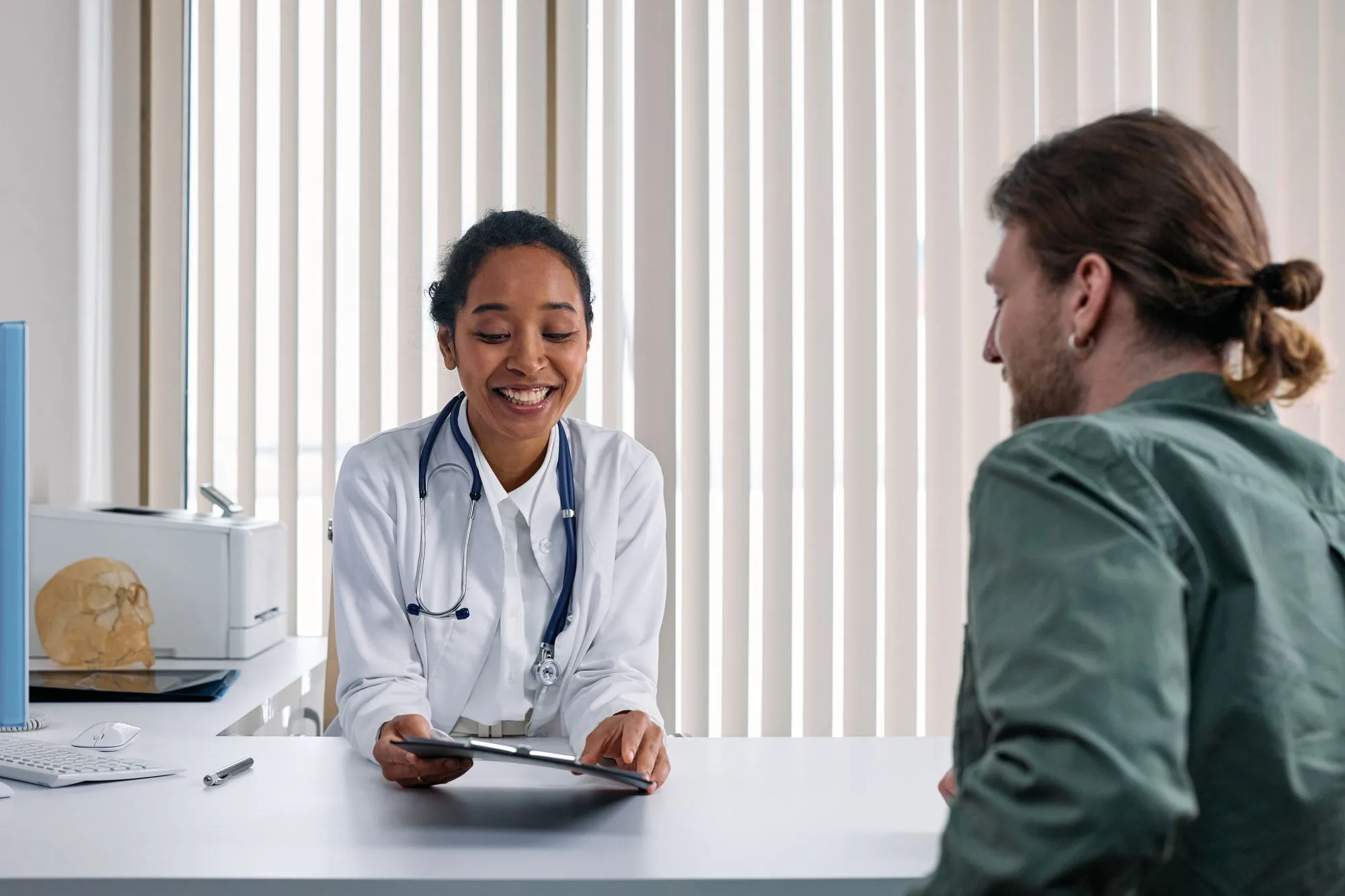 Doctor smiling while talking with a patient