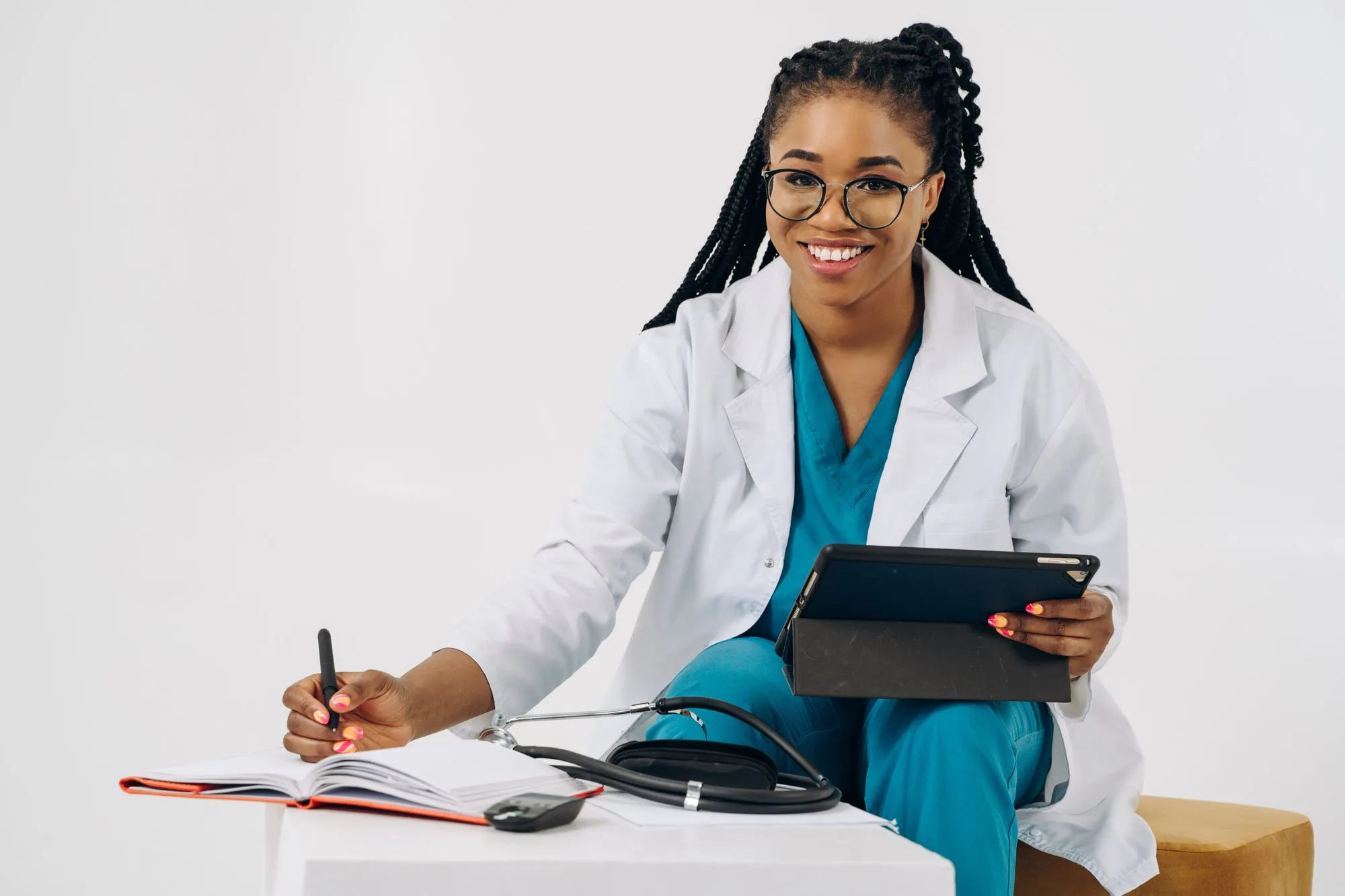 Smiling provider taking notes on a tablet